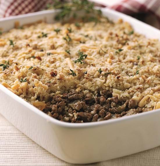 Savoury Mince Crumble A close up of the savoury mince crumble in a serving dish on a table. A serving has already been taken.
